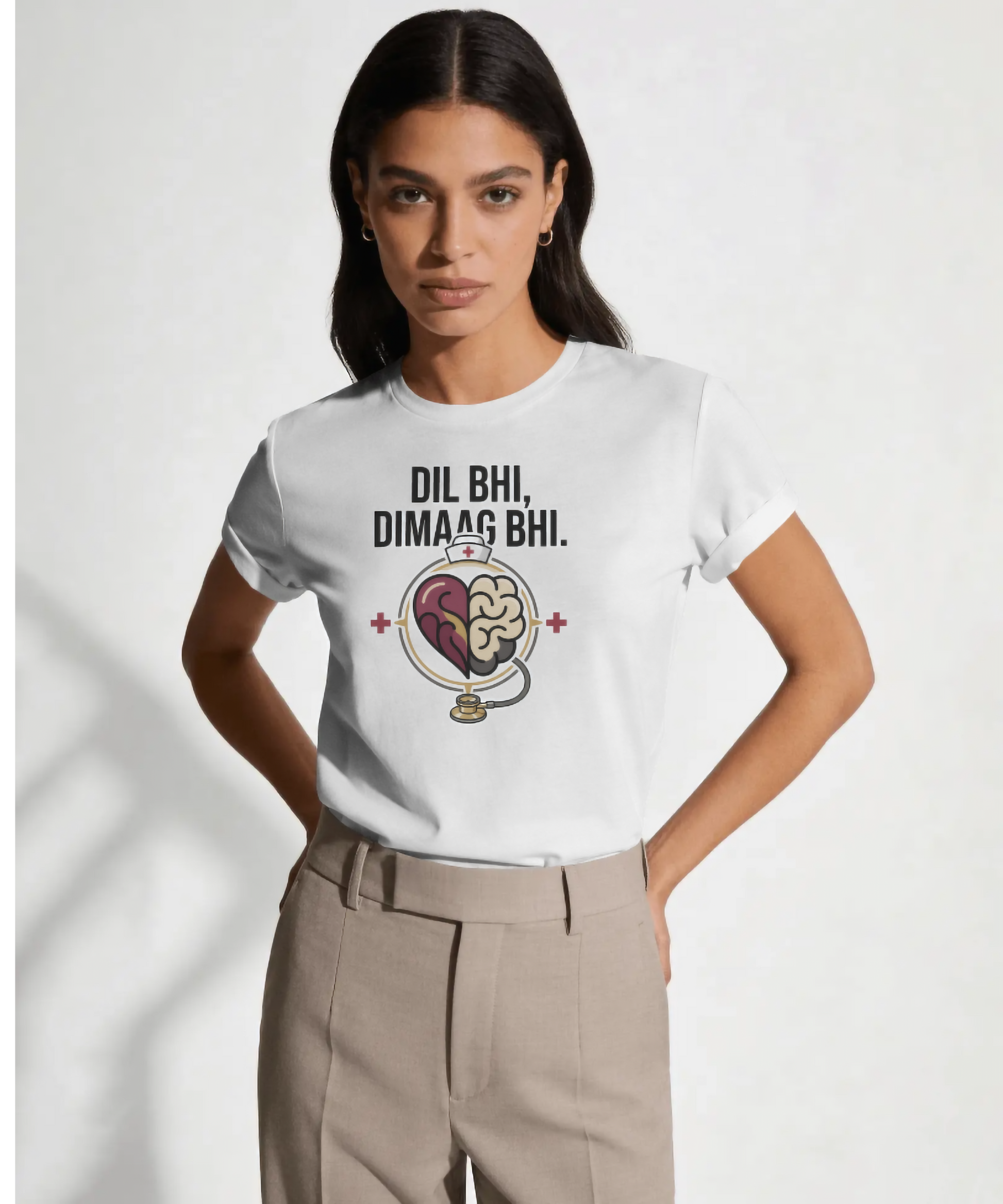 White premium women's t-shirt by Nite Stream featuring a smart medical graphic of a half-heart and half-brain encircled by a stethoscope with red crosses, along with bold typography reading 'DIL BHI, DIMAAG BHI.'