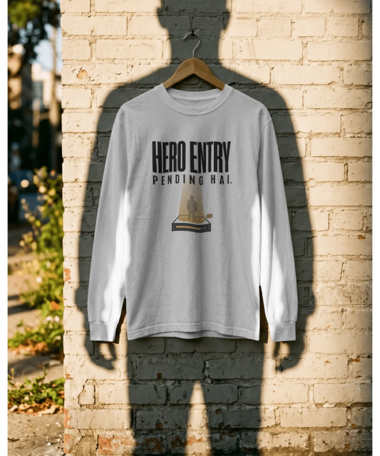 White unisex graphic t-shirt featuring the Hindi text "Hero Entry Pending Hai." The design includes a creative illustration of a person standing in a glowing teleportation beam. Premium pop-culture and cinematic streetwear by The Nite Stream.