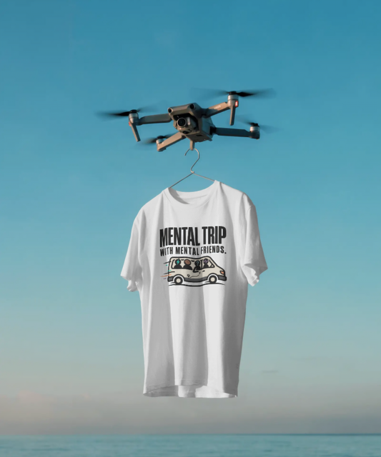 White unisex graphic t-shirt featuring the bold text "MENTAL TRIP WITH MENTAL FRIENDS." The design includes a creative illustration of a speeding van filled with crazy, energetic passengers. Premium road trip and squad streetwear by The Nite Stream.