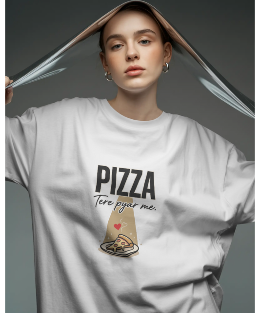 A smiling woman modeling a white graphic t-shirt. The t-shirt features the bold text "PIZZA" and the cursive Hindi text "Tere pyar me." above a cute illustration of a glowing pizza slice. Premium, quirky food-lover streetwear by The Nite Stream.
