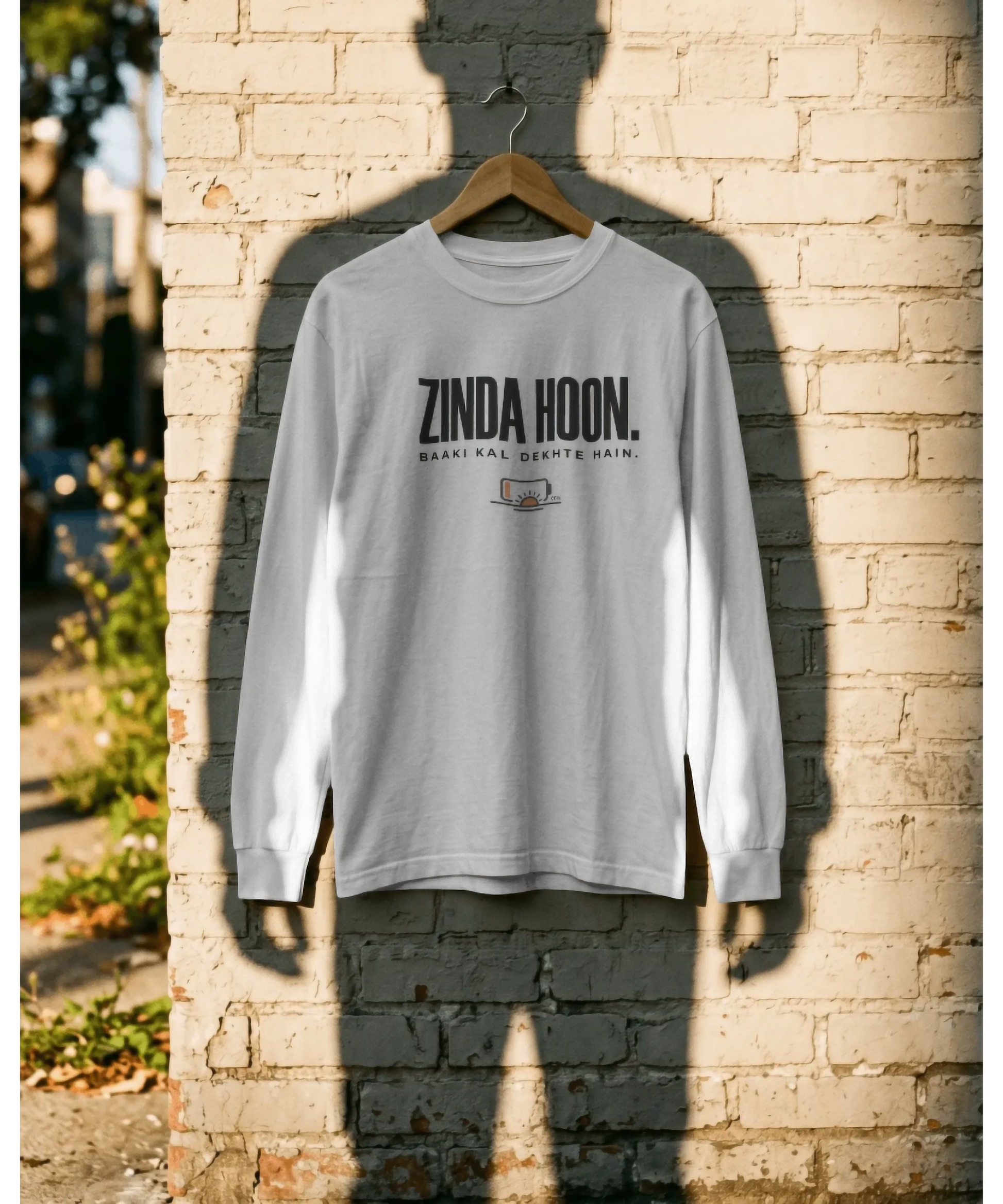 White unisex graphic t-shirt featuring the Hindi quote "Zinda Hoon. Baaki Kal Dekhte Hain." in bold typography with a low battery icon. Premium casual streetwear for relaxing and unwinding, by The Nite Stream.